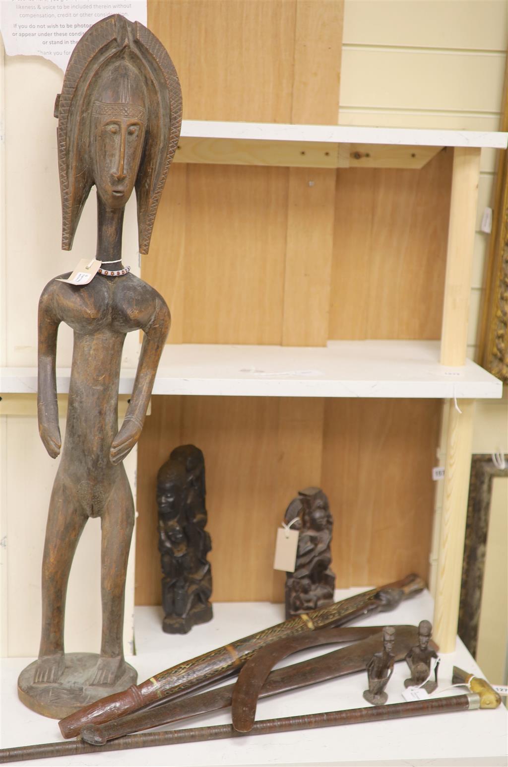 Ethnographia, a collection of various wood carvings, including an African tall female fertility figure,